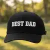 Black low‑profile cotton dad hat with BEST DAD text and metal buckle closure, one size 55–60 cm